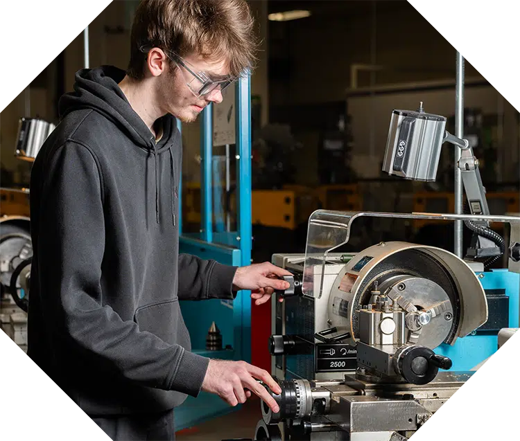 Engineering student working on machine