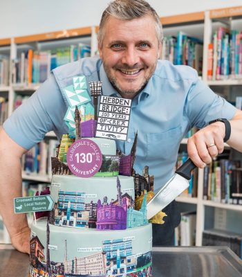 Principal David Malone cutting Calderdale College's 130th anniversary cake