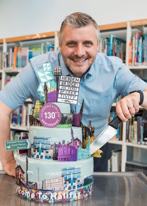 Principal David Malone cutting Calderdale College's 130th anniversary cake